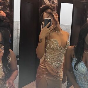 Handmade diamond corset with long silky gold train gown giving a luxurious feel.